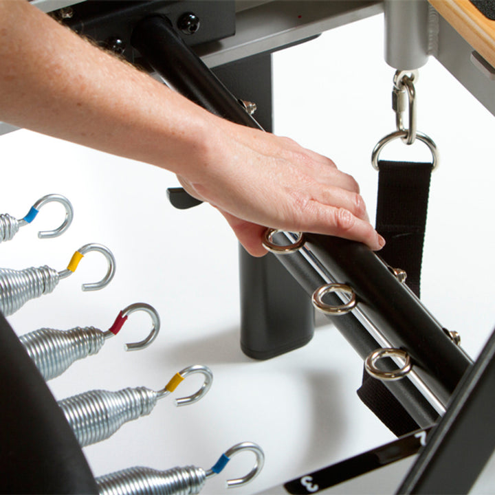 Professional Studio Reformer with Large Footplate, Adjustable Four-Position Gear Bar, Locking Foot Bar, Vertical Storage Design, and Integrated Side-Split Platform for Group Classes